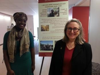 Professor Eileen Doll and student with presentation boards